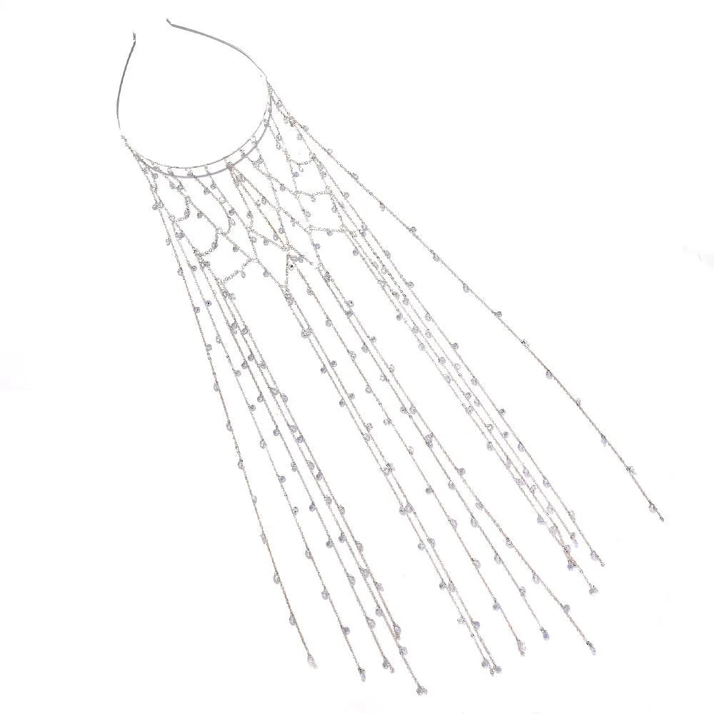 Gold rhinestone mesh headband with a tassel detail on a model's hair.