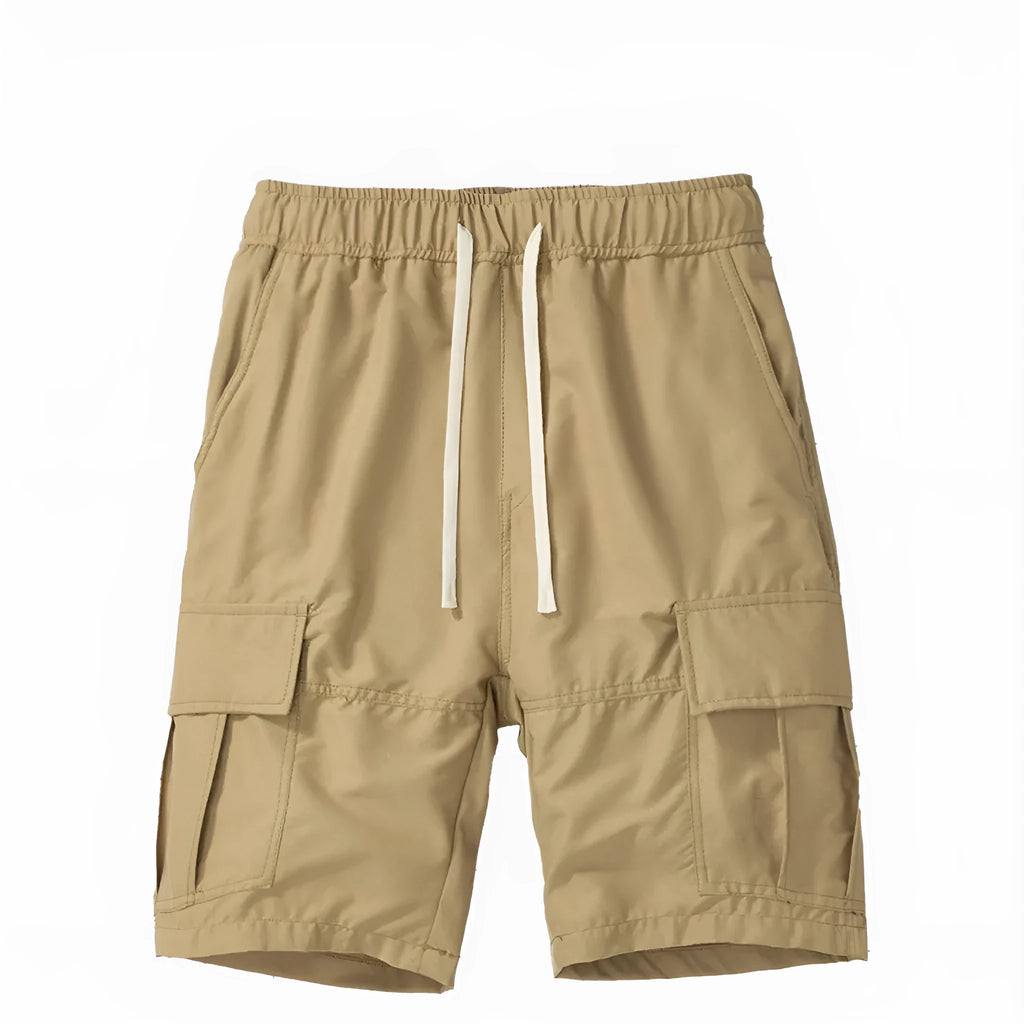 Man wearing loose-fitting multi-pocket cropped trousers in a dark colour for summer casual style.