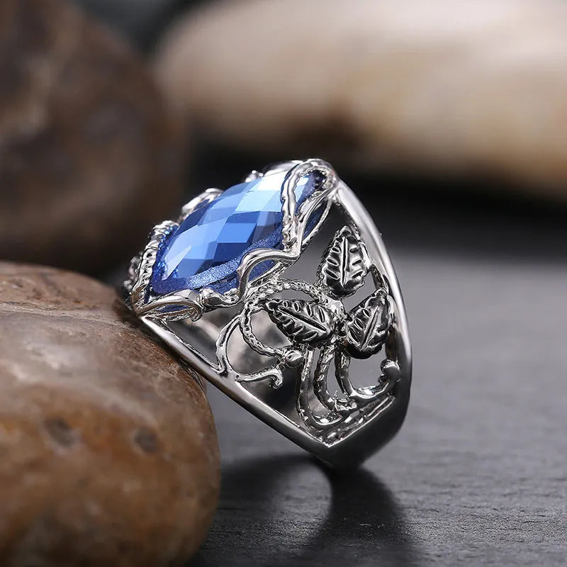 Blue horse eye shaped crystal ring for women on a hand, showing its geometric alloy design.