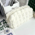 Beige fabric pencil case with cream puff design and zip closure for pens and stationery
