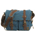 Men's brown canvas crossbody shoulder bag with cowhide trim and flap closure.