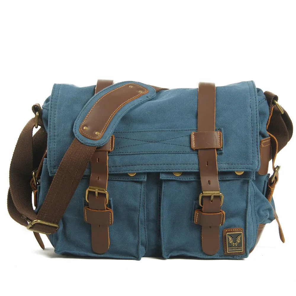 Men's brown canvas crossbody shoulder bag with cowhide trim and flap closure.