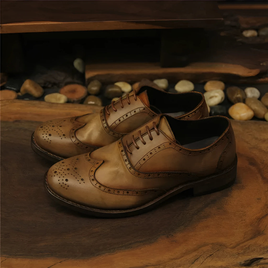 Men's light brown distressed leather shoes with vintage engraved detailing and round toe