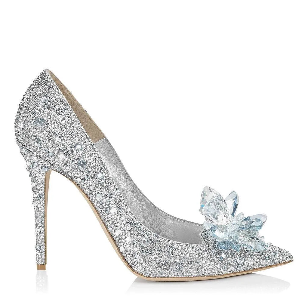 Gold women's pointed toe high heels with rhinestones and a stiletto heel on a white background.