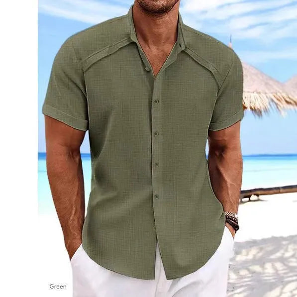Man wearing a solid colour short sleeve Hawaiian casual shirt in a cotton blend fabric.