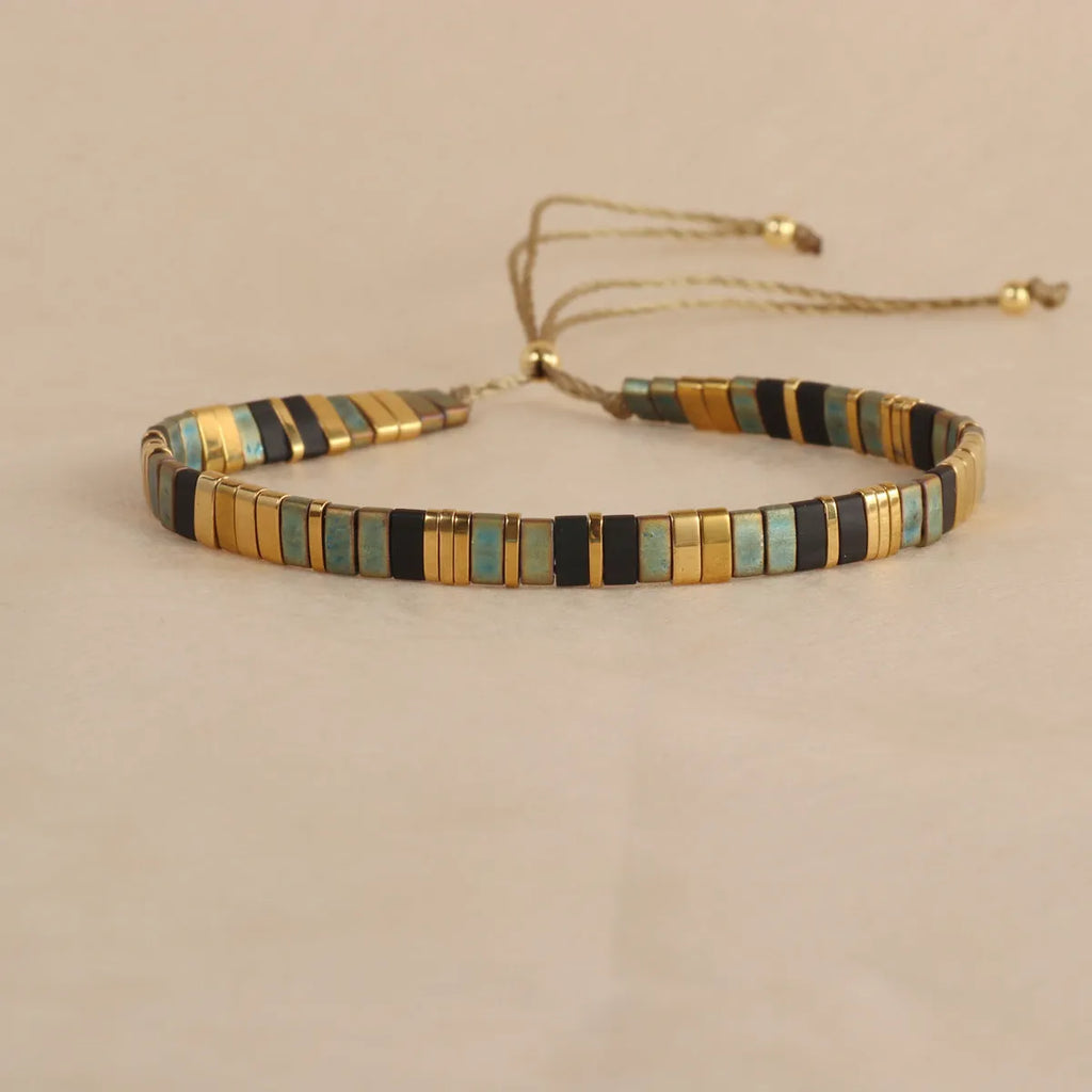 Geometric glass bead bracelet with pull beads design on a wrist, shown in milky white colour.