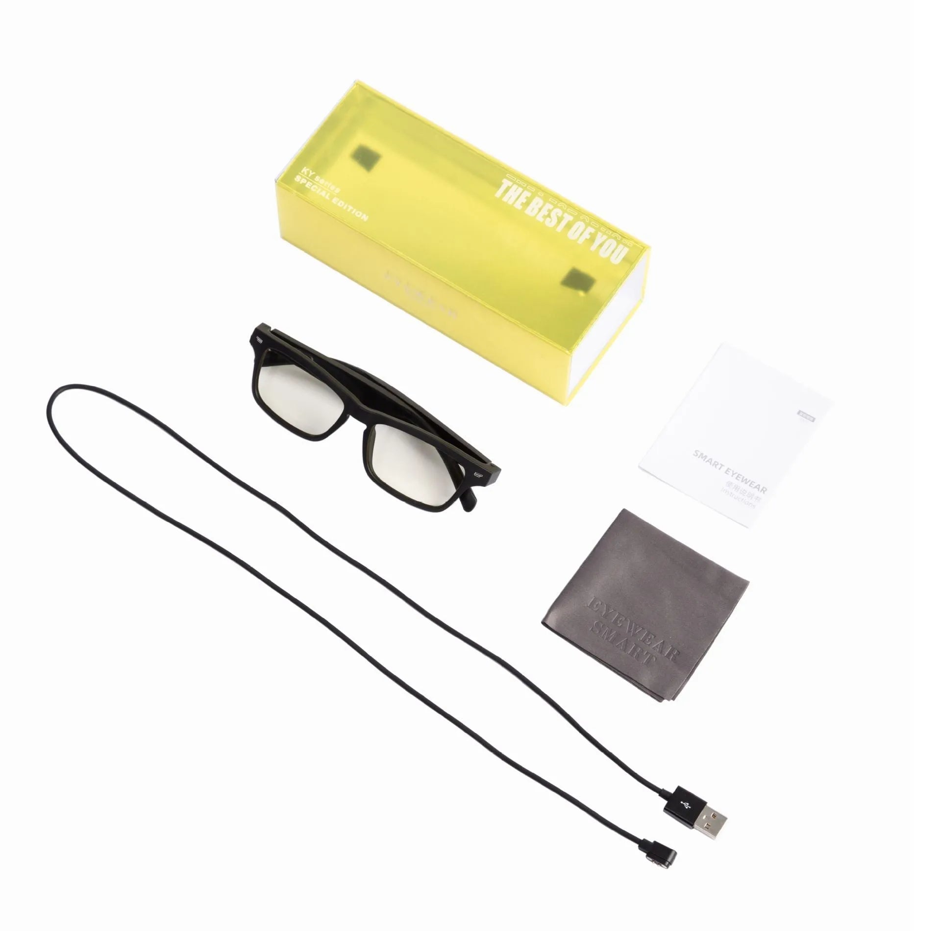 Black Bluetooth smart glasses with semi-open ear speakers and interchangeable lenses on a table with case.