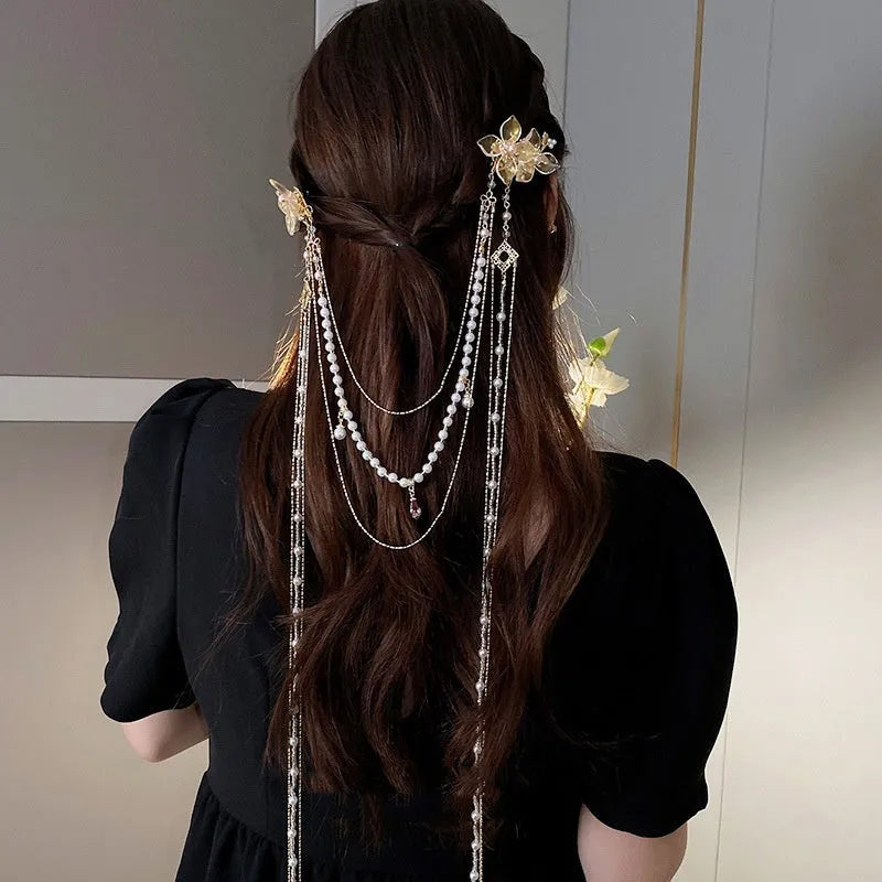Gold acrylic hairpin with pearl, diamond, and long tassel decorative elements for women's hairstyling.