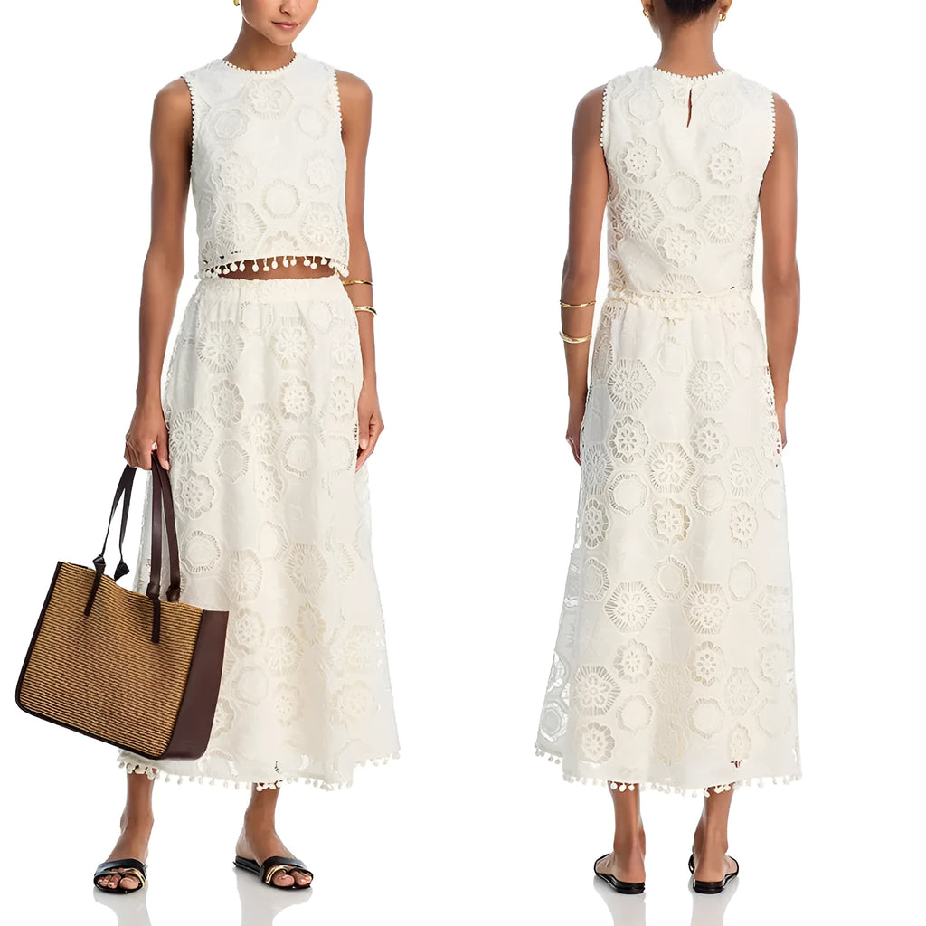 White women's retro suit with embroidery details showing sleeveless top and long skirt