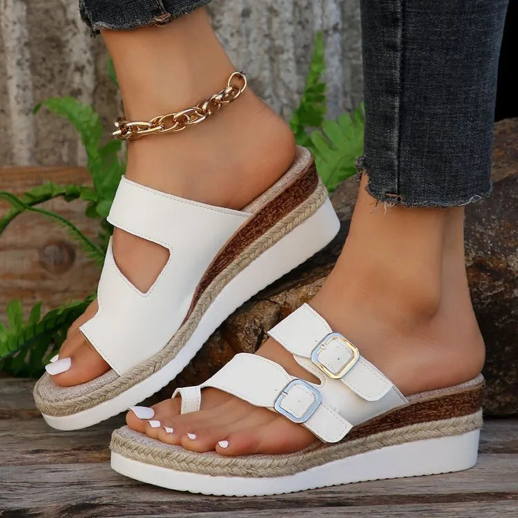White patent leather wedge sandals with woven design and finger fit straps