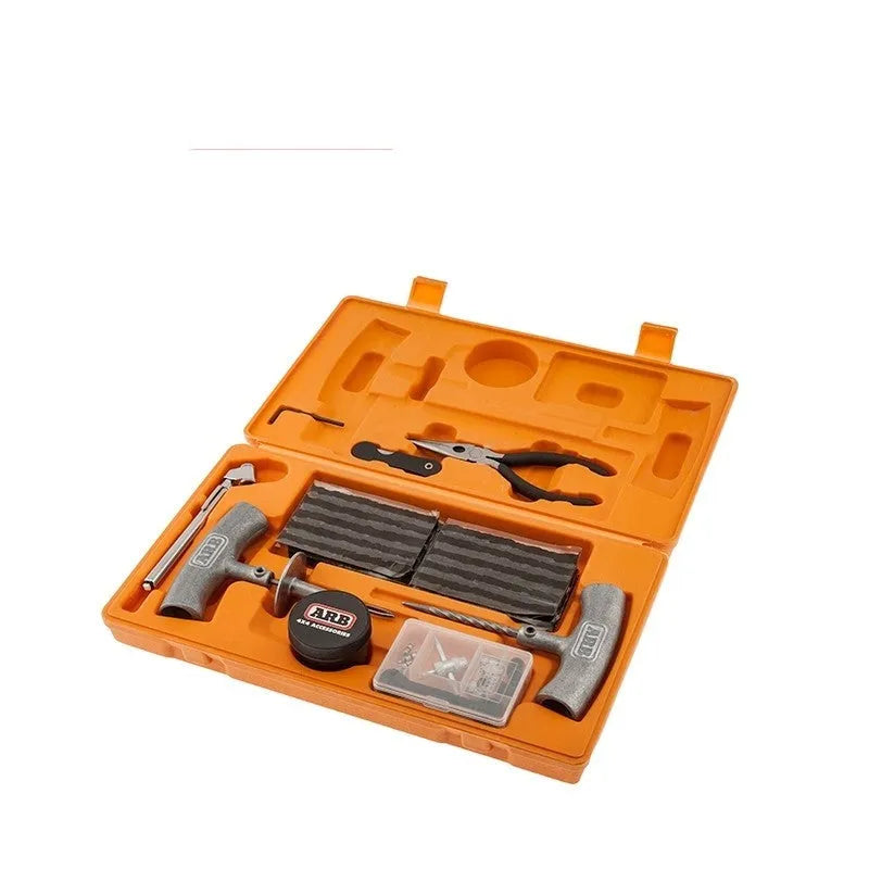 Emergency tyre repair tool kit with rubber strips, steel tools, and pressure gauge in a yellow carry case.