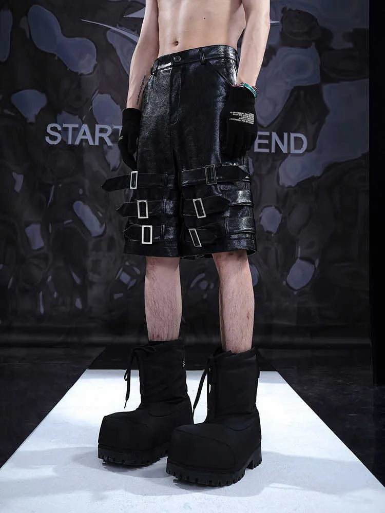 Men's black PU leather casual shorts with a distinctive ring design on the leg, shown in a cropped fit.