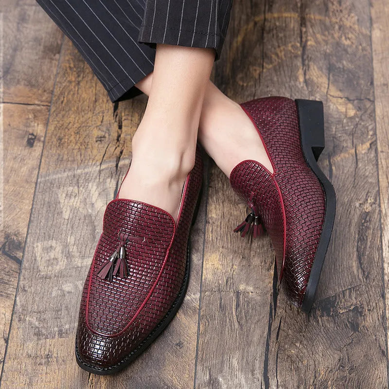 Men's black slip-on business shoes with pointed toe and tassel detail on artificial PU upper