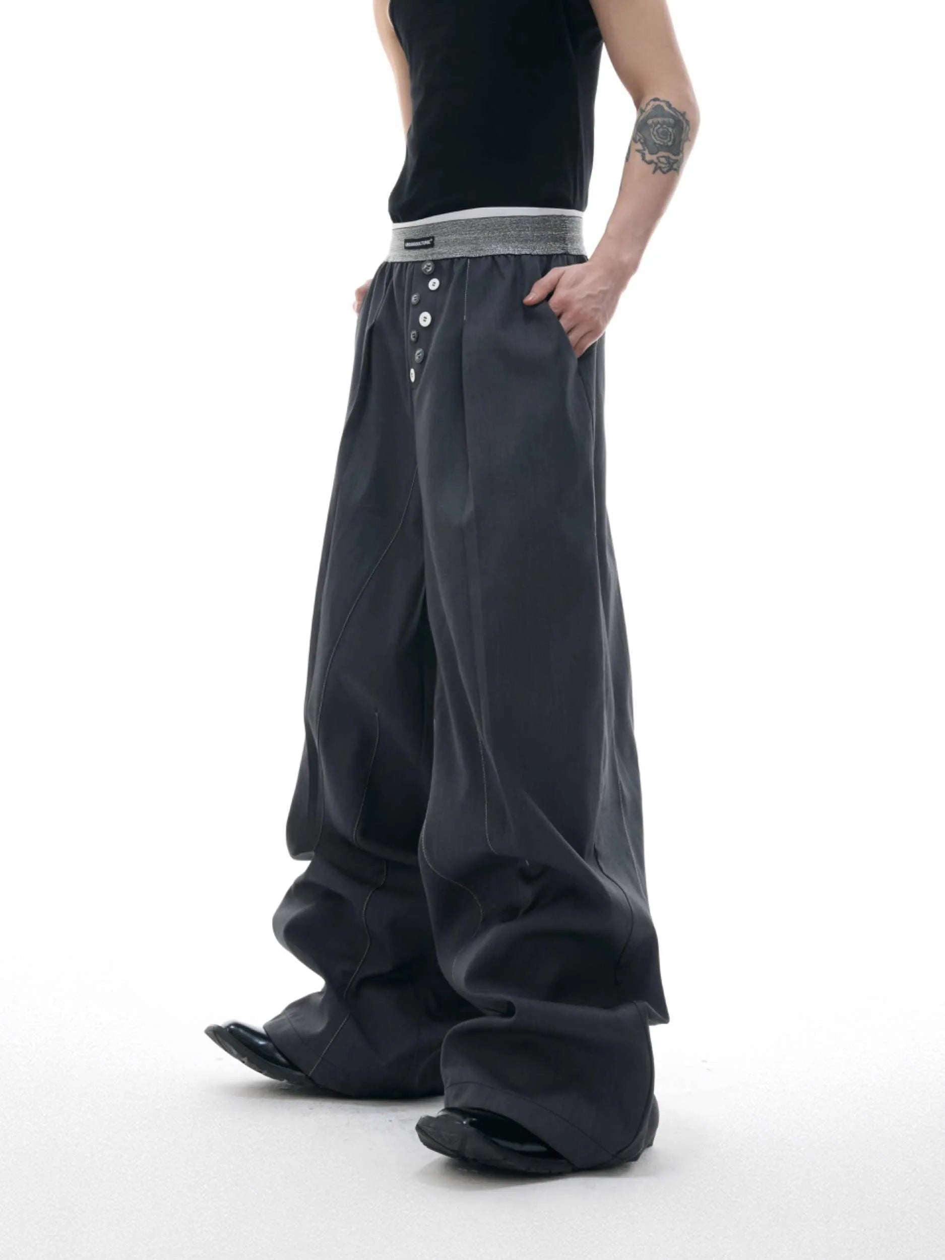 High-waisted drooping straight-leg trousers in black with button open line design detail.
