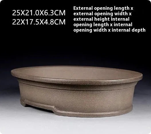 Handmade antique oval purple sand ceramic bonsai pot measuring 25cm by 21cm by 6.3cm