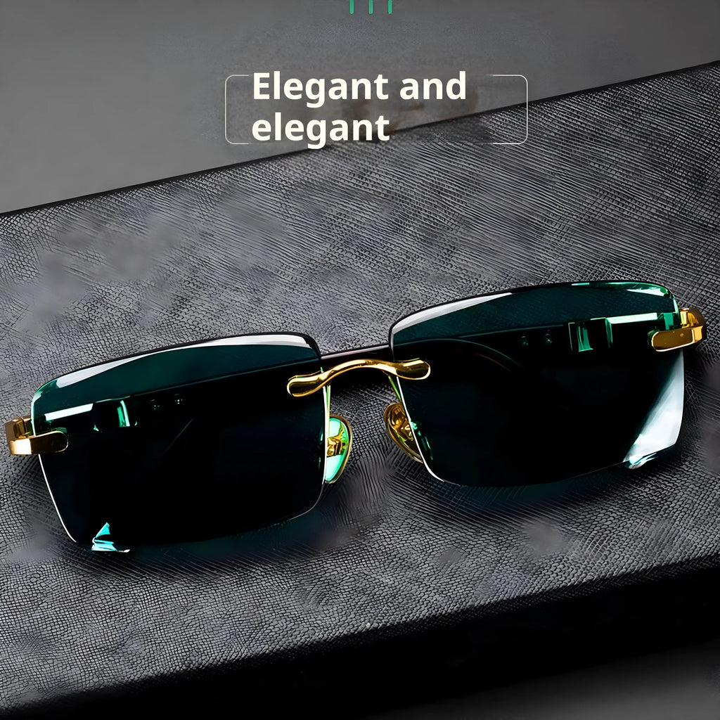 A pair of frameless sunglasses with dark green crystal lenses, shown with a glasses case and cleaning cloth.