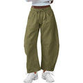 Woman wearing loose grey cropped sweatpants with drawstring waist and side pockets, street fashion style.
