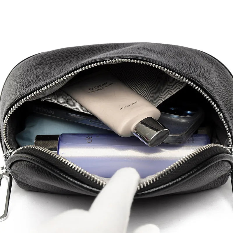 Soft black PU women's saddle-shaped messenger bag with a single crossbody strap and external pocket.