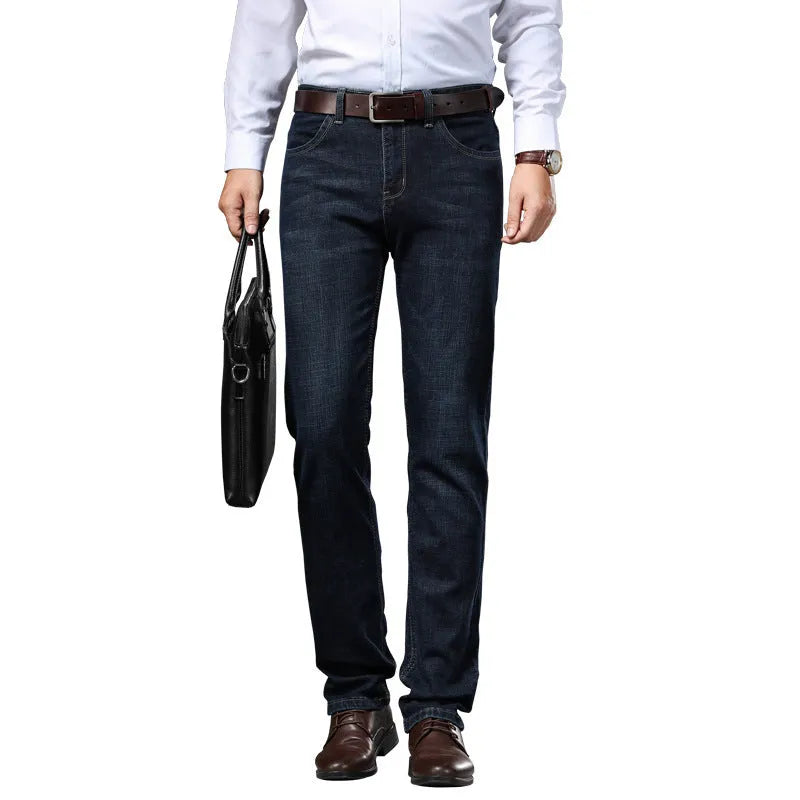 Men's black stretch denim jeans showing loose straight-leg fit with mid waist and zip fly detail