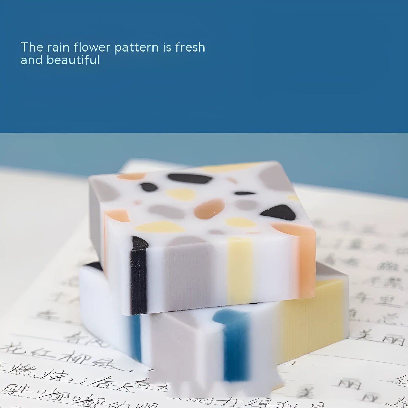 A single white rubber eraser in a brick shape with straight edges, for cleaning pencil marks from paper.