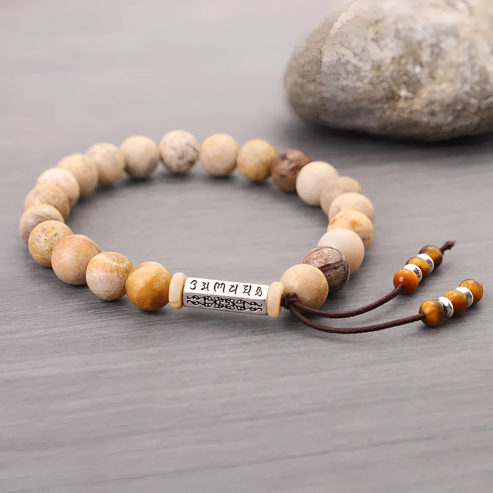 Original design handmade stone bead bracelet in natural wood colour on wrist.