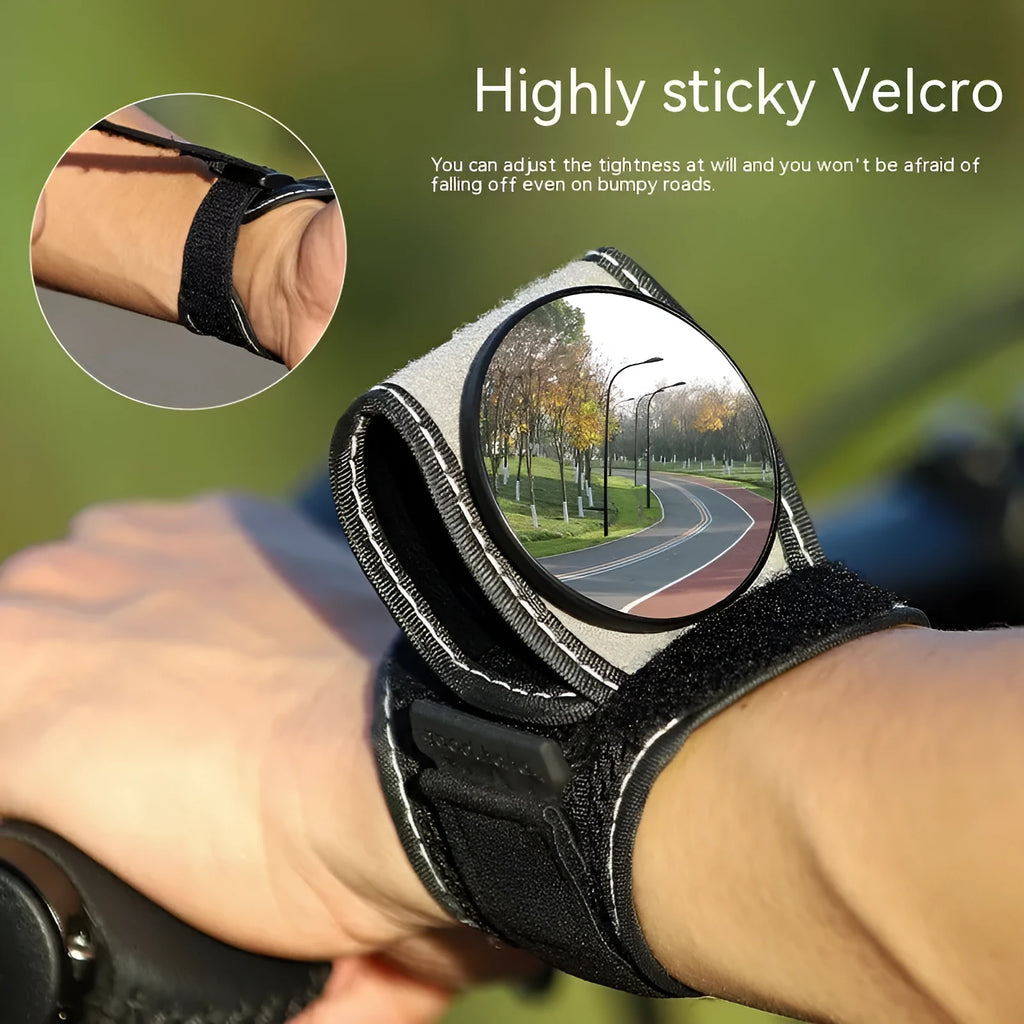 Black bicycle rear-view mirror mounted on an adjustable nylon wrist strap for cycling.