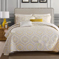 Quilted pure cotton bed cover set with printed pattern on a bed