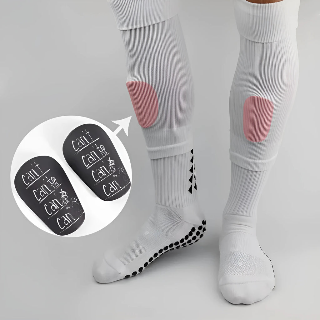 Football training shin guard in Pu material, colour black, size S, placed on grass