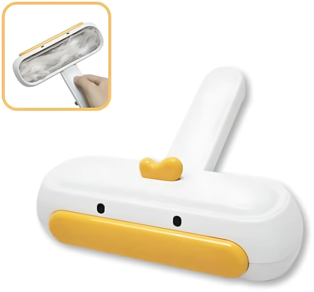 Yellow duck design portable manual pet hair remover tool on a fabric surface.