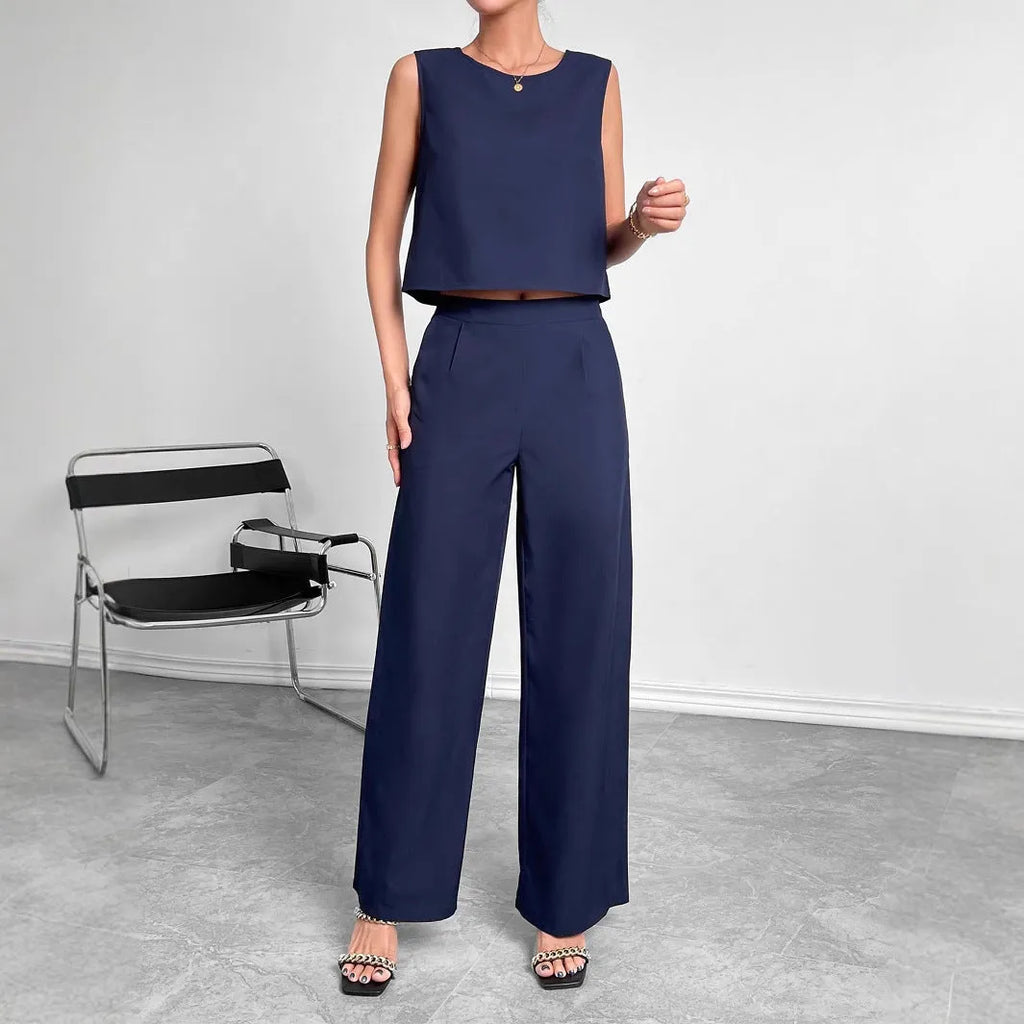 Women's red polyester two-piece set featuring a sleeveless top and wide-leg trousers on a hanger.