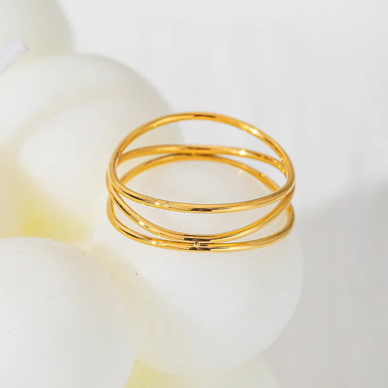 Gold colour titanium steel women's ring with three-layer geometric line design in coiled construction