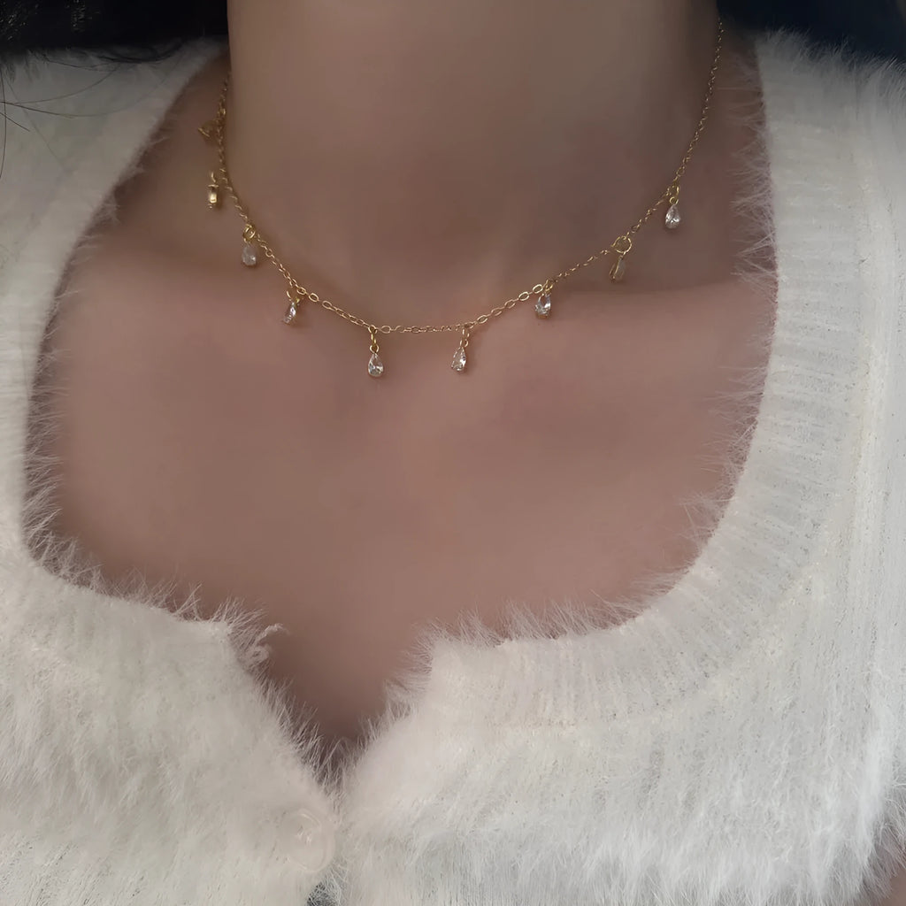 Zircon jewellery set with geometric necklace, matching earrings, and anklet featuring meteor shower design