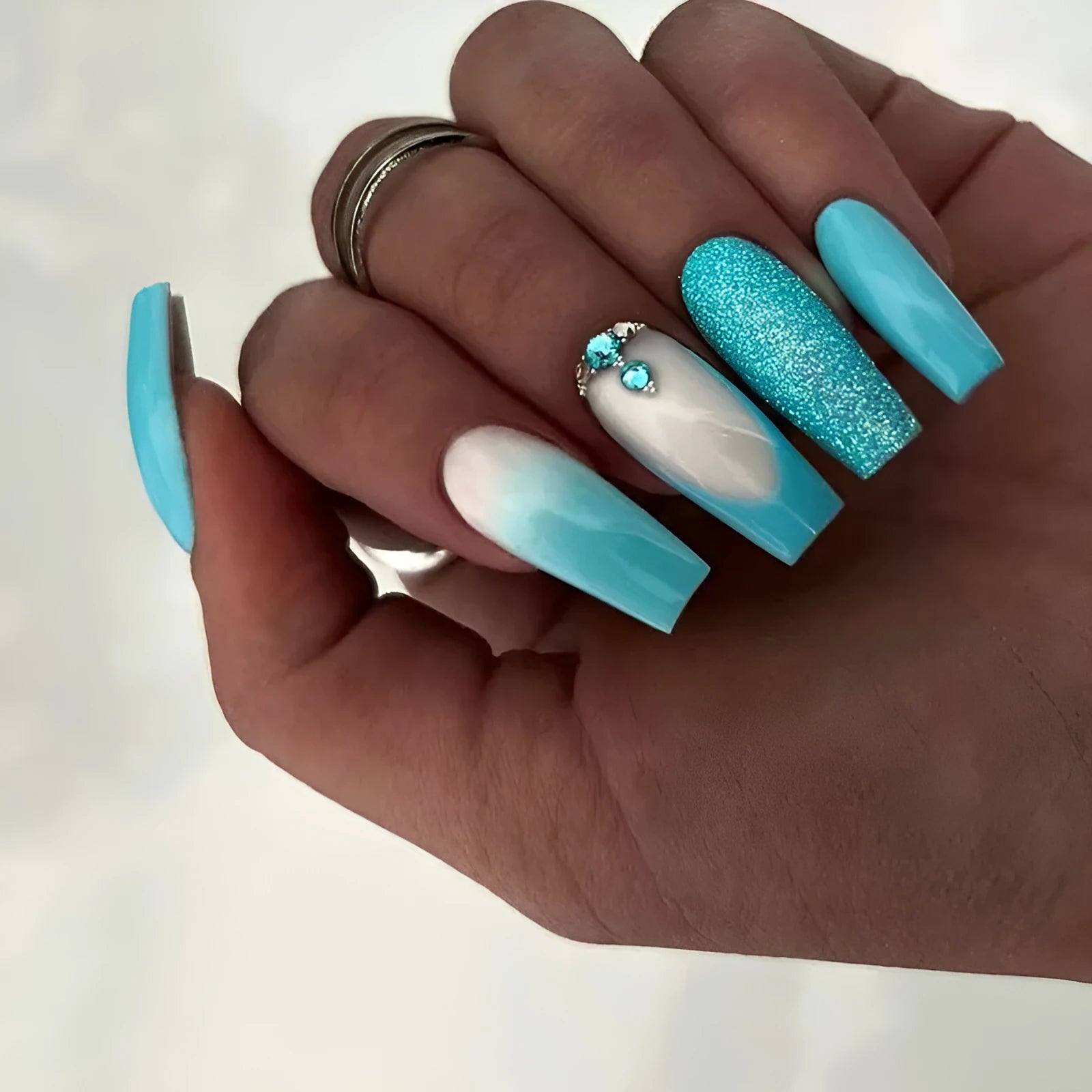 Long ballet shape press-on nails with smart blue diamond glitter pattern and glue