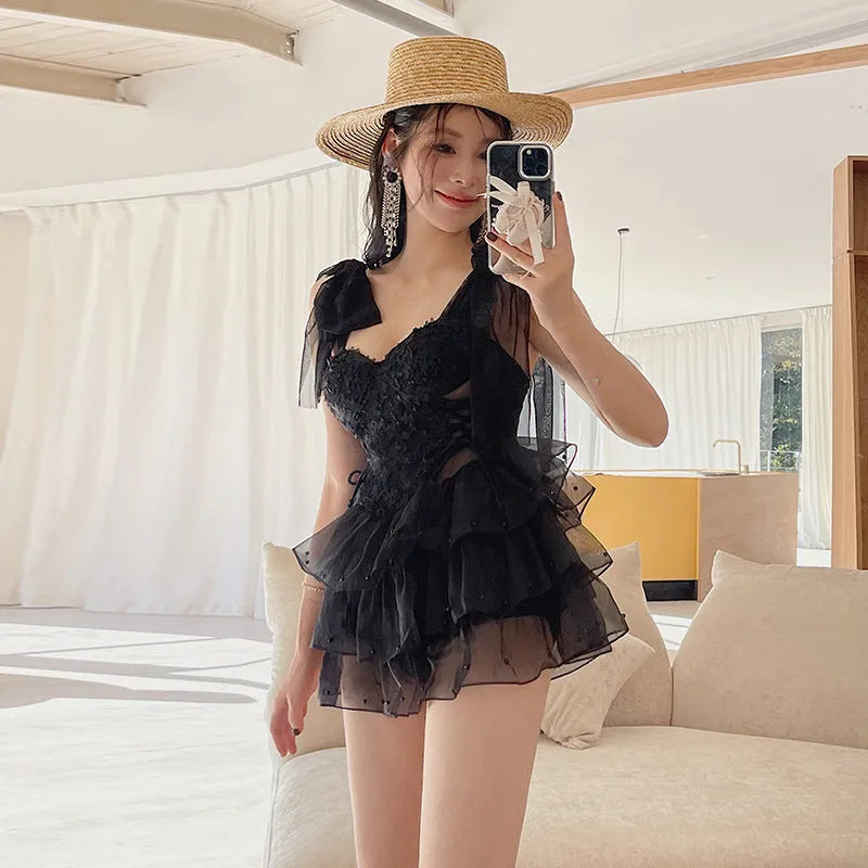 Black women's one-piece swimsuit with gathered chest detail and conservative fit.