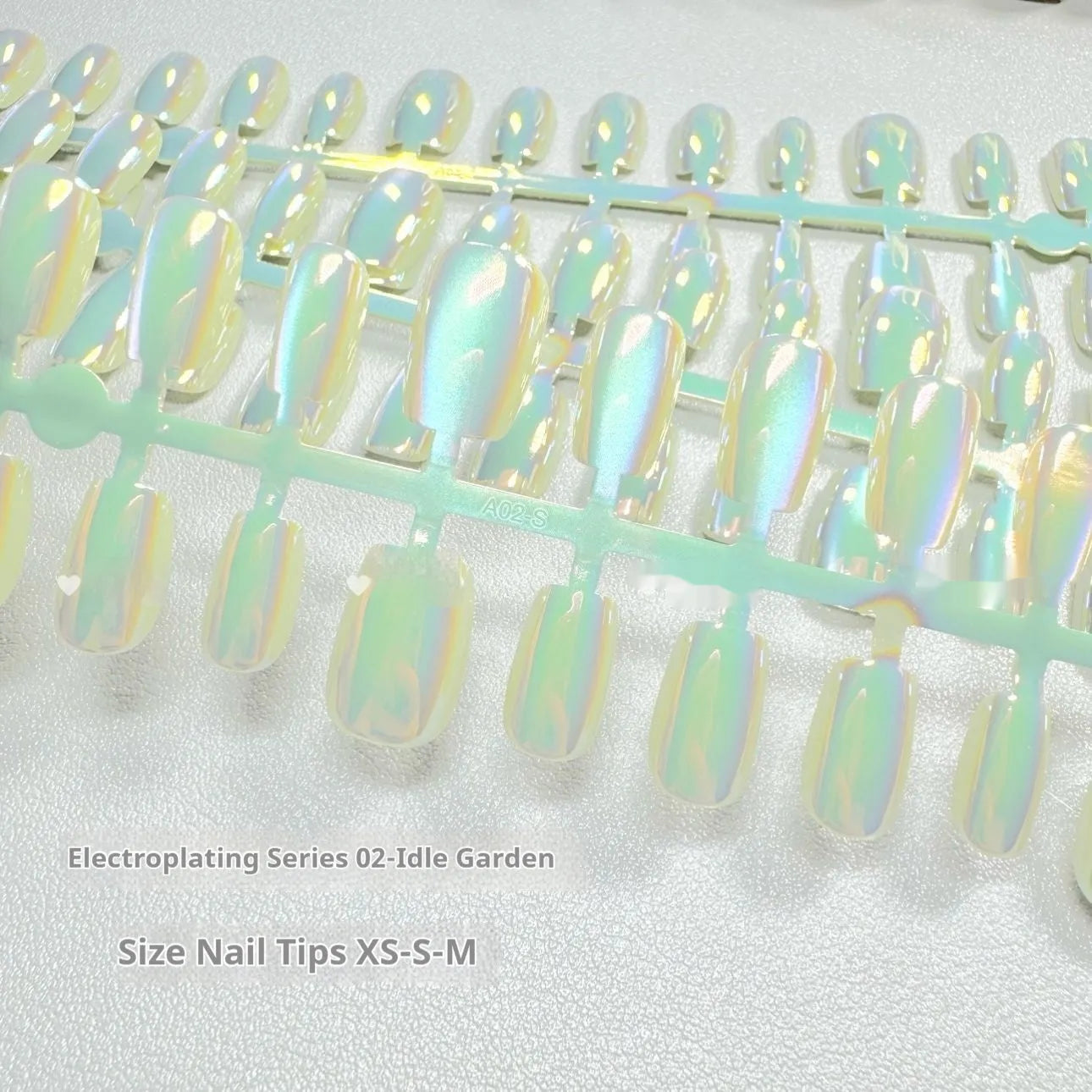 Electroplated Cat's Eye aurora glitter false nails in short ladder shapes on a white background.