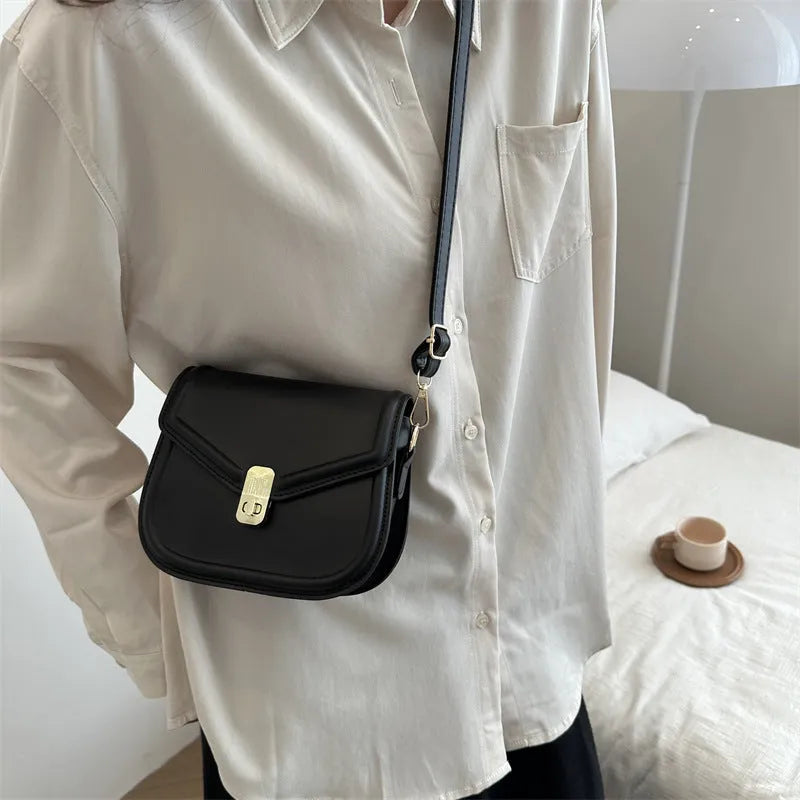Soft PU leather messenger bag with clamshell opening shown in horizontal square shape on a shoulder strap.