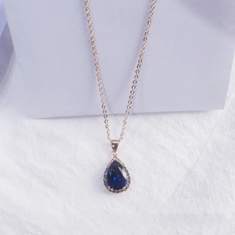 Rose gold electroplated necklace with water drop shaped geometric pendant and rhinestone detailing