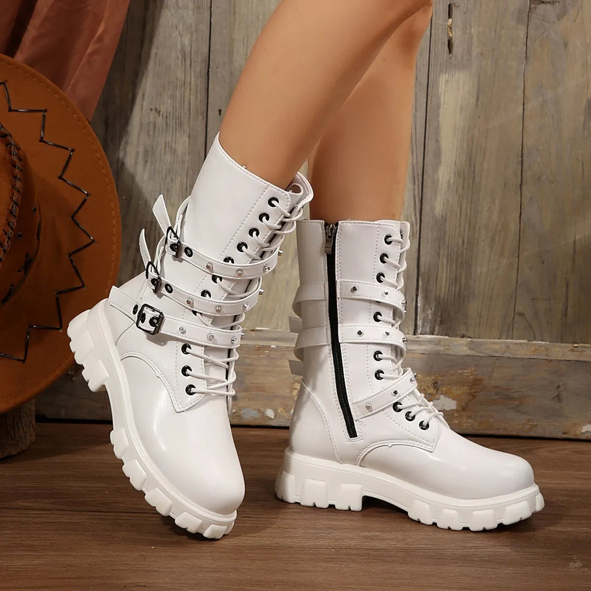 Black women's mid-calf boots with a large metal buckle and side zipper, featuring a round toe.