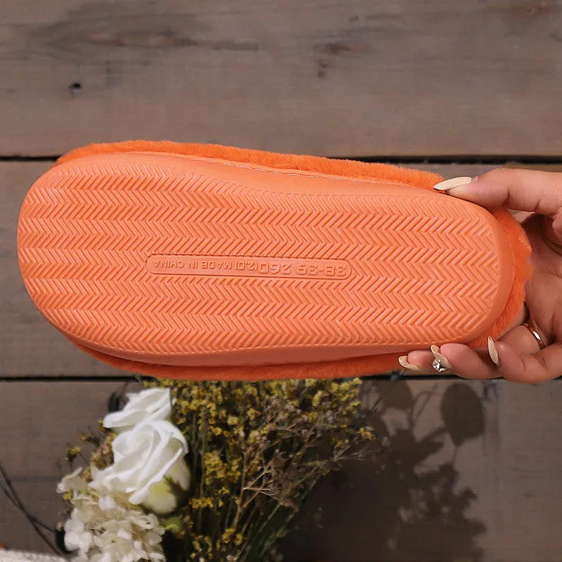 Orange Halloween pumpkin slippers with coral velvet exterior and plush lining