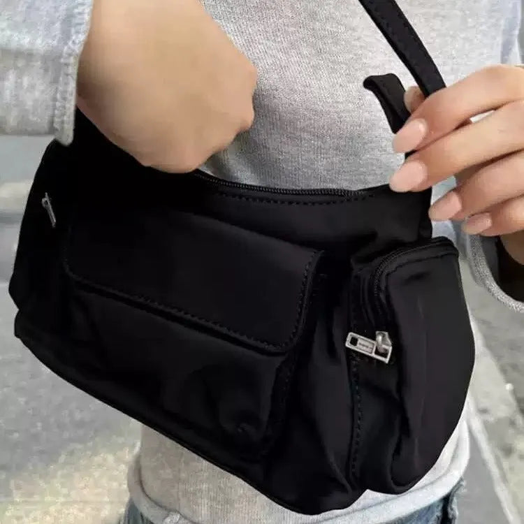 Black nylon lightweight shoulder bag with double pockets and side line detailing.
