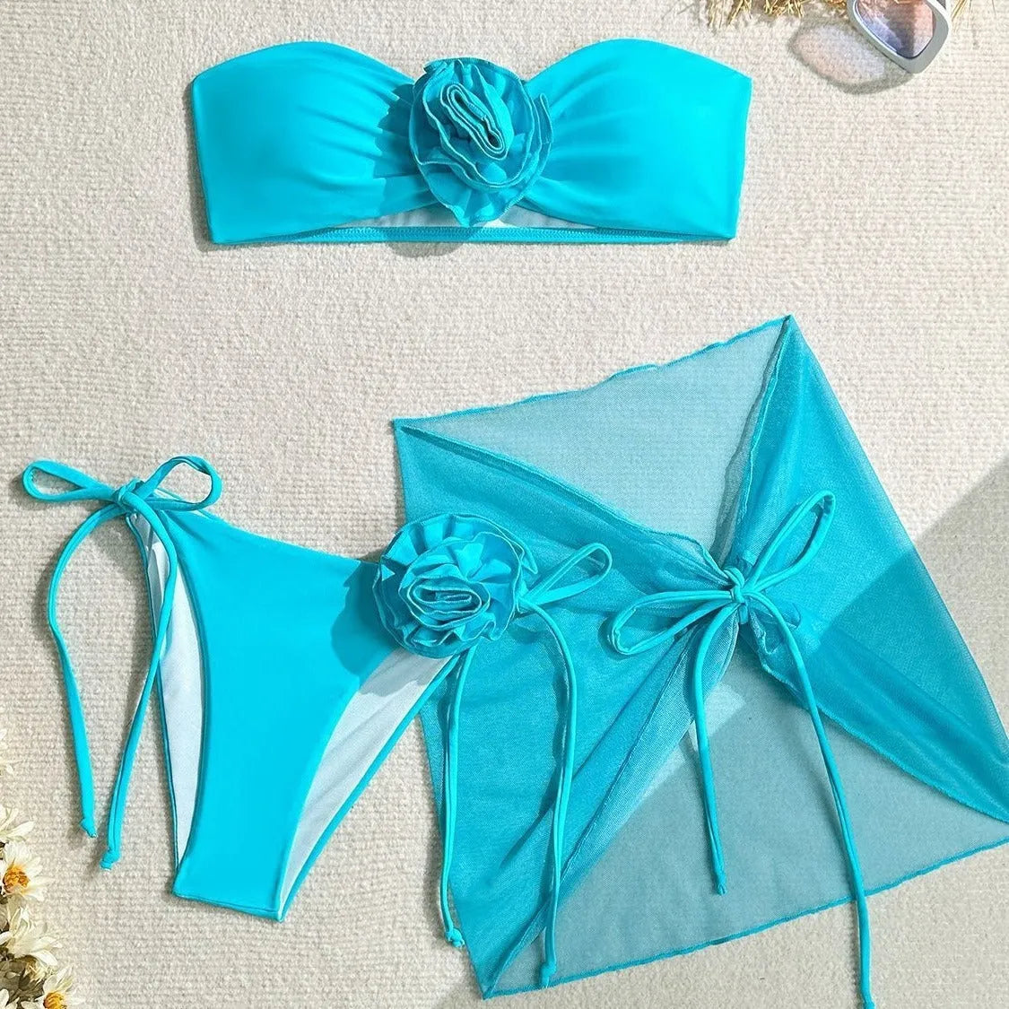 Women's pink tube top swimsuit with a large three-dimensional flower tie detail.