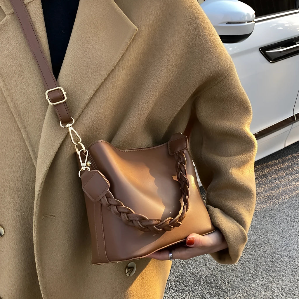 Retro brown bucket bag with weaving pattern, showing crossbody strap and underarm design