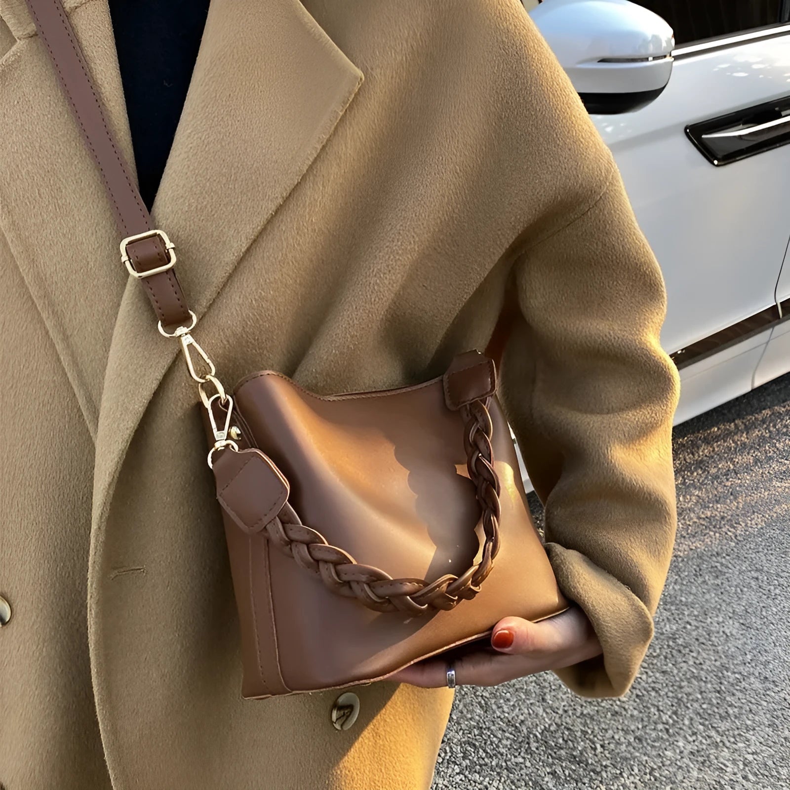 Retro brown bucket bag with weaving pattern, showing crossbody strap and underarm design