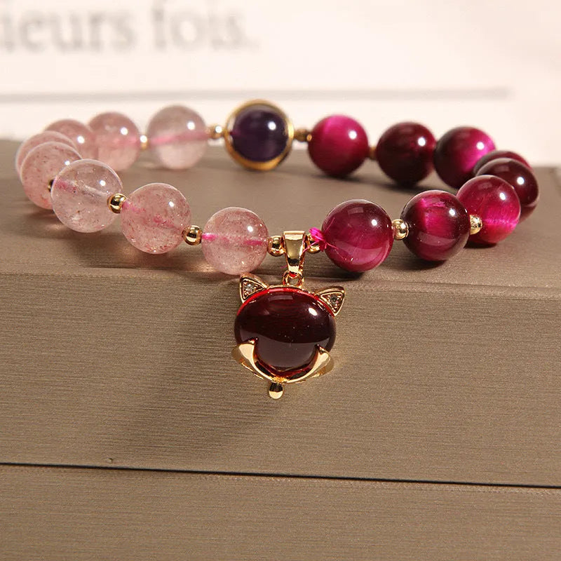 Strawberry crystal bracelet on wrist showing elastic rope construction and natural stone colour