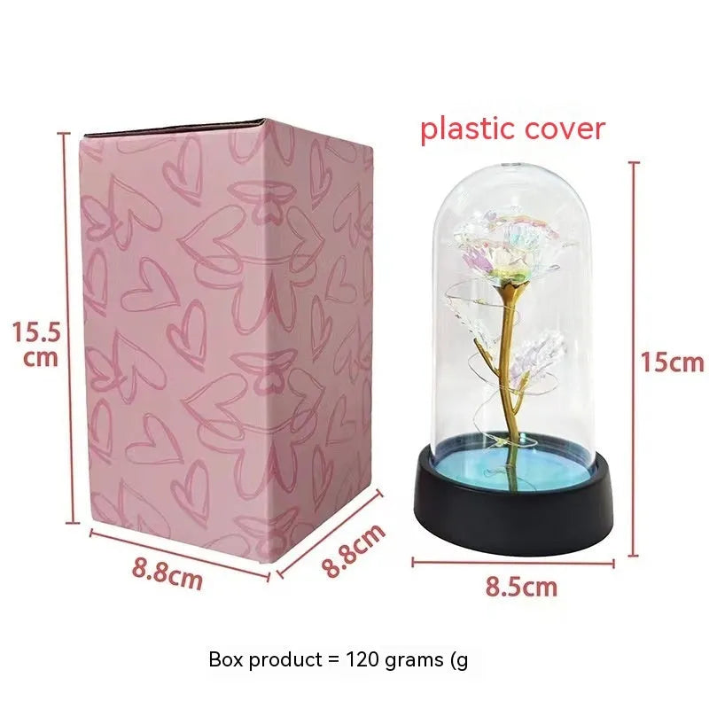 Small plastic night lamp with glass cover and decorative flowers, 15cm tall on black base