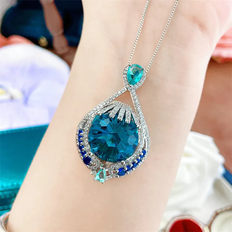 Blue geometric pendant necklace with fireworks-cut crystals on water wave chain