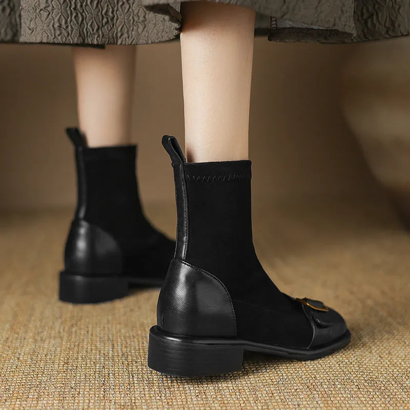 Women's black low heel Martin boots with round toe, belt buckle stitching, and lace-up front.