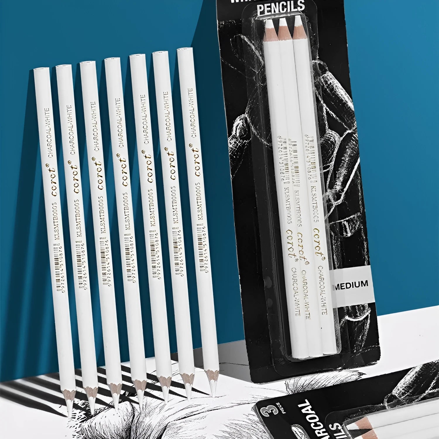 Three white charcoal pencils for sketching and highlighting on dark paper