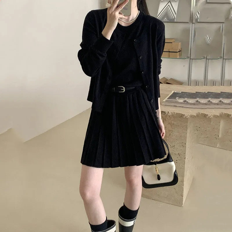 Women's grey knitted national style two-piece set with cardigan, pleated vest skirt, and belt.