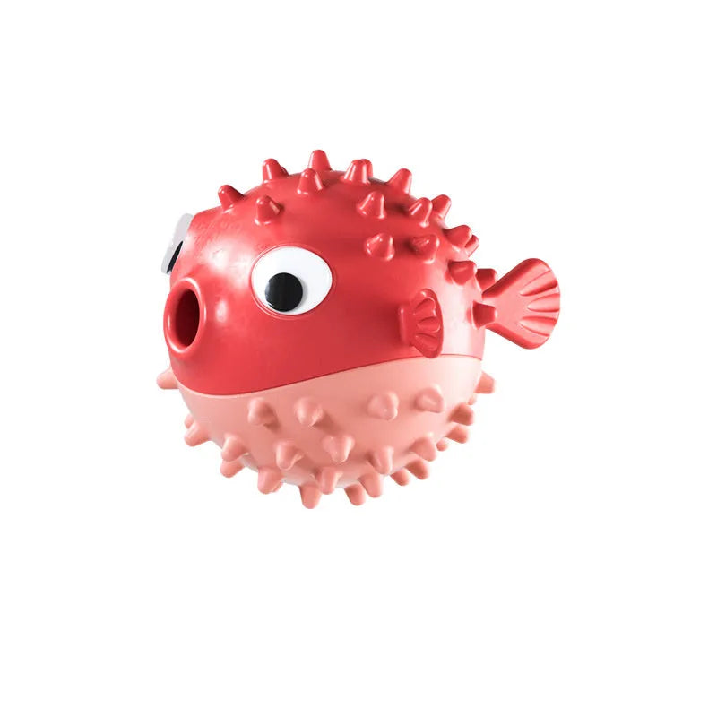 Green fish-shaped interactive dog toy with treat dispensing slots and raised cleaning texture